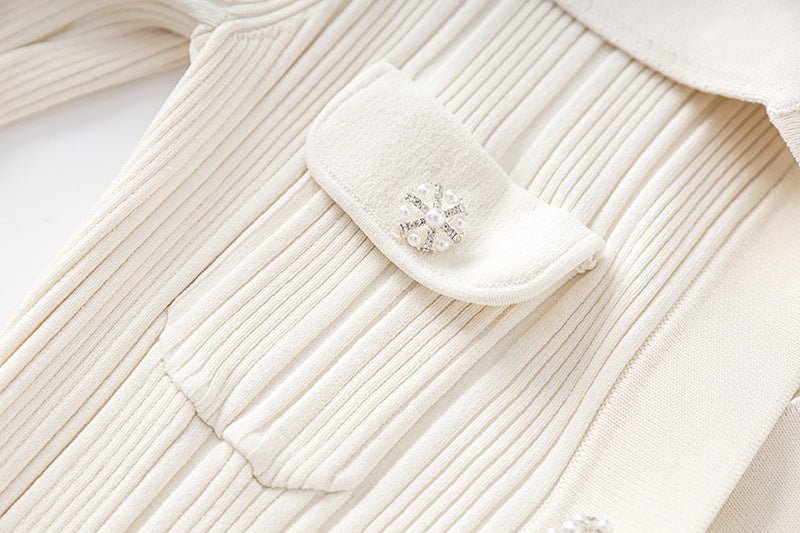 White ribbed knit button-down blouse with flared hemline