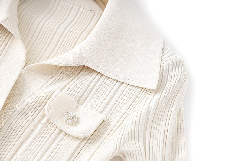 White ribbed knit button-down flared hemline top with collar and pockets