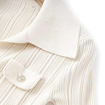 White ribbed knit button down shirt with flared hemline and decorative buttons