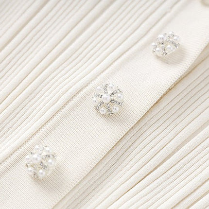 White ribbed knit button-down with flared hemline and decorative buttons
