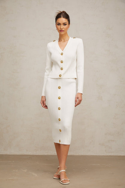 White ribbed knit jacket and skirt set featuring a coordinated design with matching textures and color