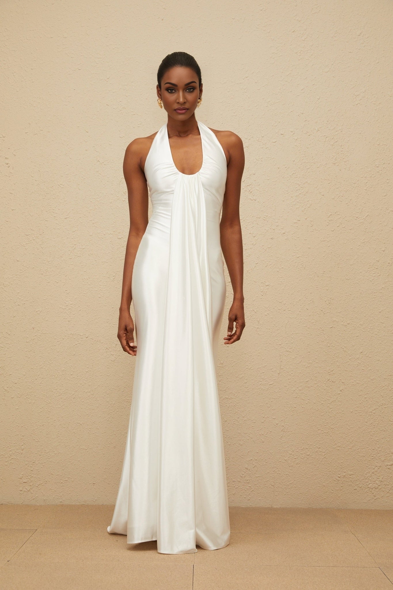 White satin halterneck maxi dress with ruched detailing and ribbon design