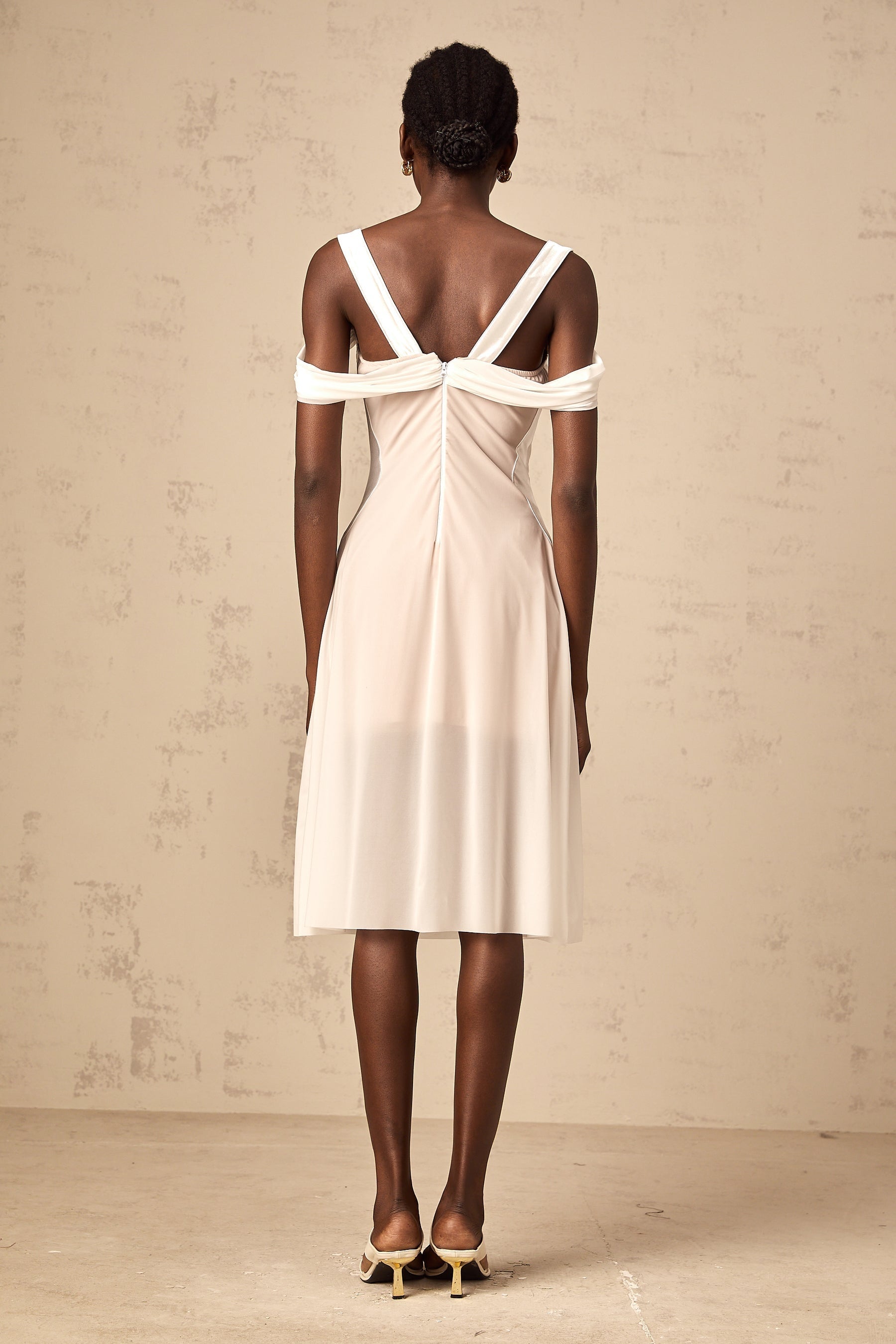 White semi sheer ruched midi dress on a mannequin or model