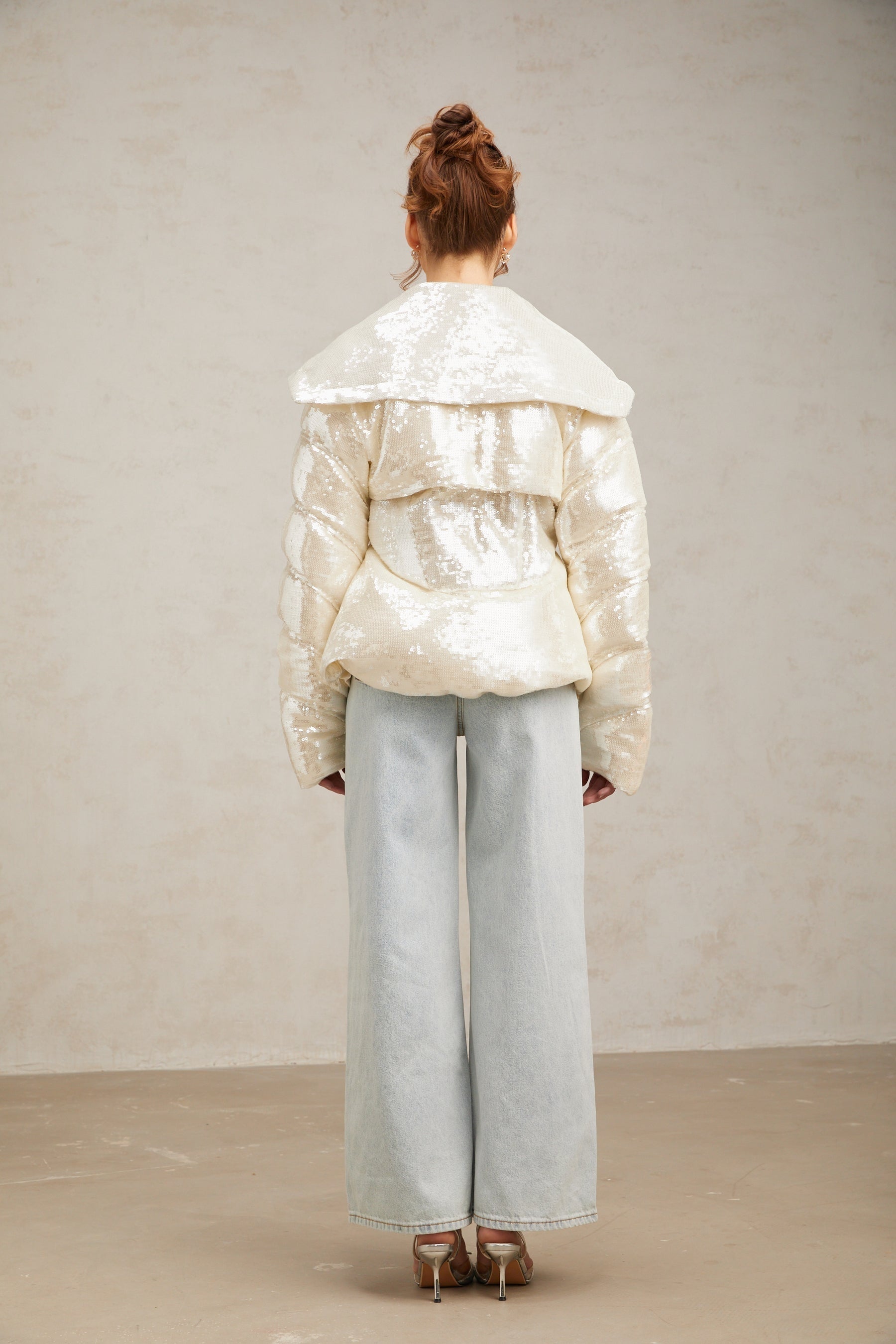 White sequined winter coat with down filling and long length featuring shiny embellishments