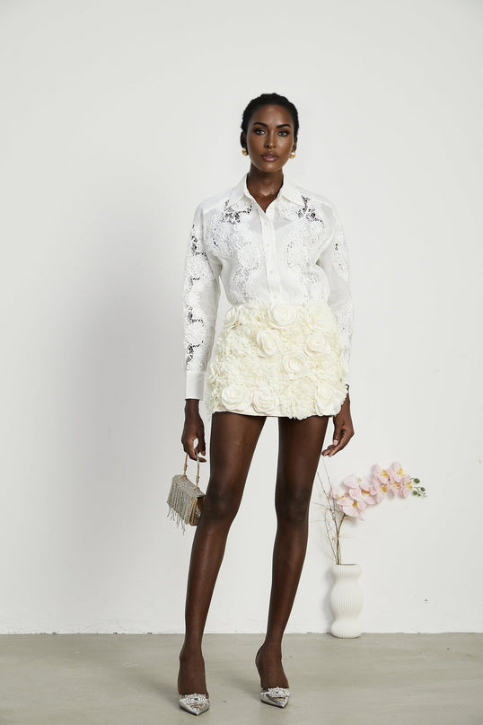 White shirt with lace embroidery detailing and cutout design featuring long sleeves and collar