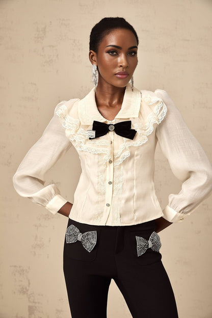 White shirt with lace trim and bow detail at neckline