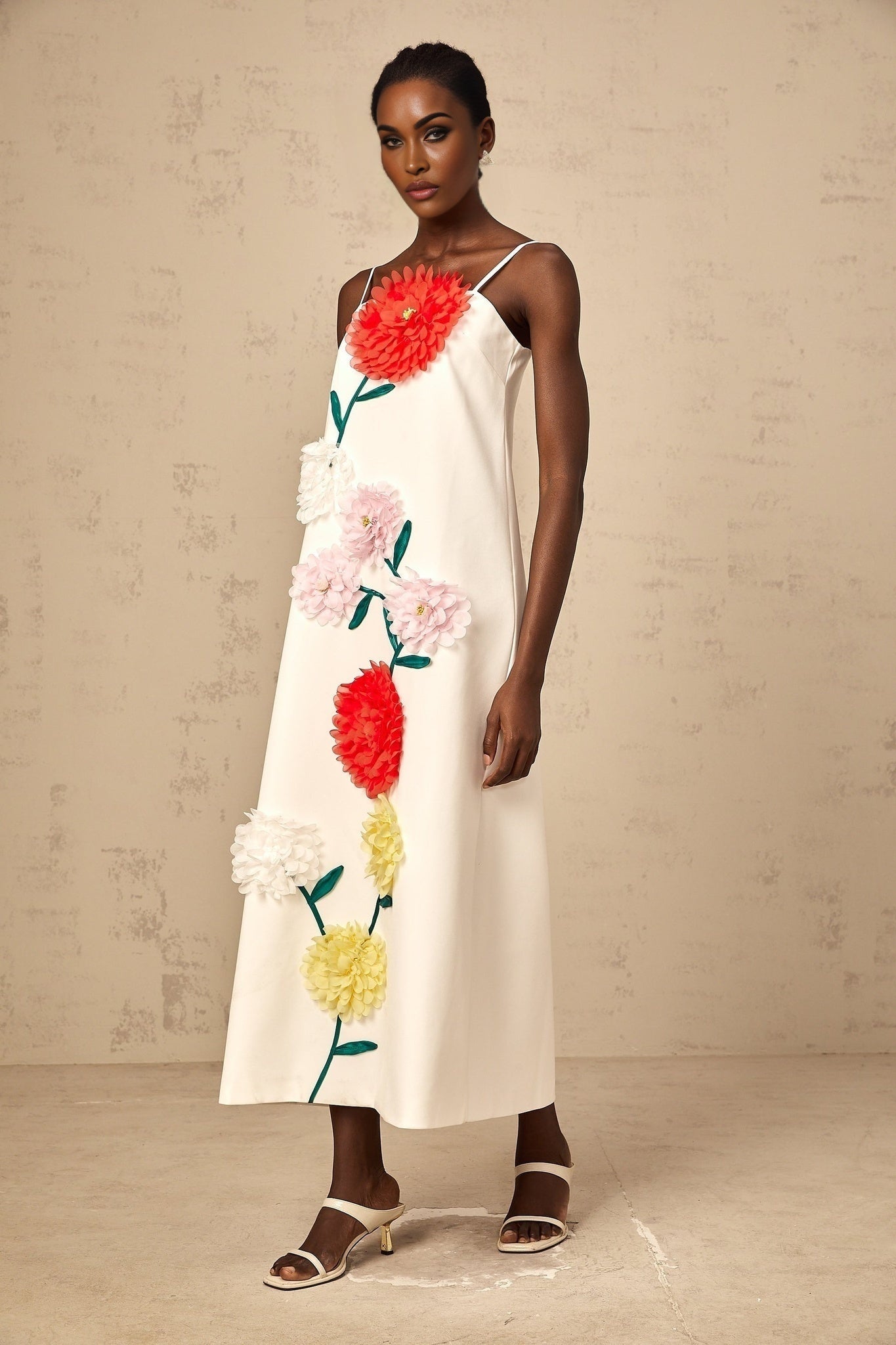 White sleeveless midi dress with three dimensional petal details on the bodice
