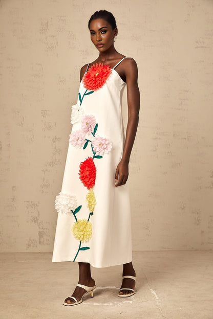 White sleeveless midi dress with three dimensional petal details on the bodice