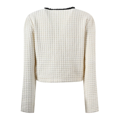 White tailored jacket and flared skirt with black accents, structured and slightly cropped style, ideal for spring or fall formal events