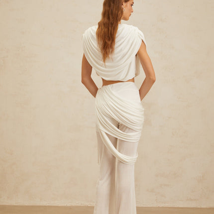 White Sleeveless Bateau Neck Cropped Top and High Rise Flared Hem White Trousers with Ruched Detailing and Draped Asymmetrical Design