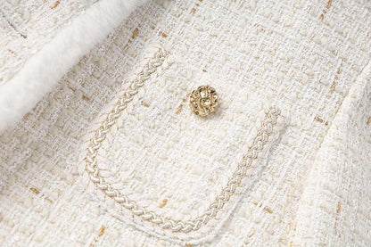 Elegant white tweed coat with fur trim and gold accents