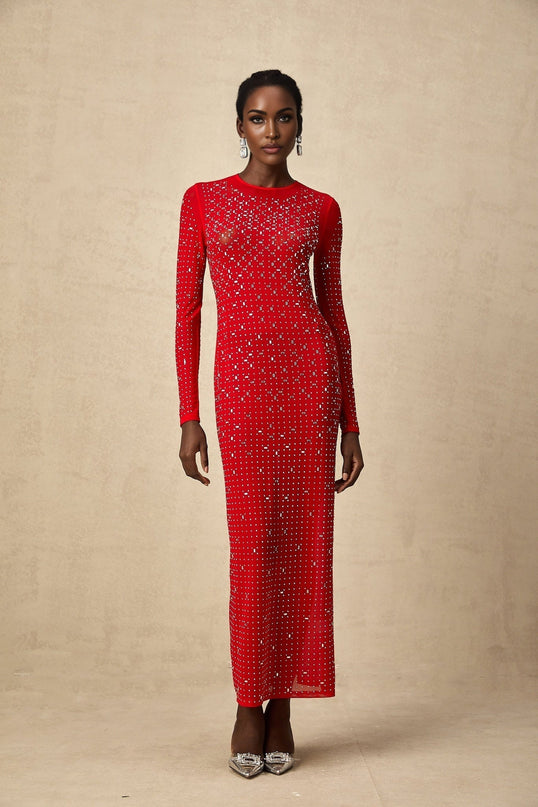 Woman in flowing red tulle maxi dress adorned with sparkling rhinestones