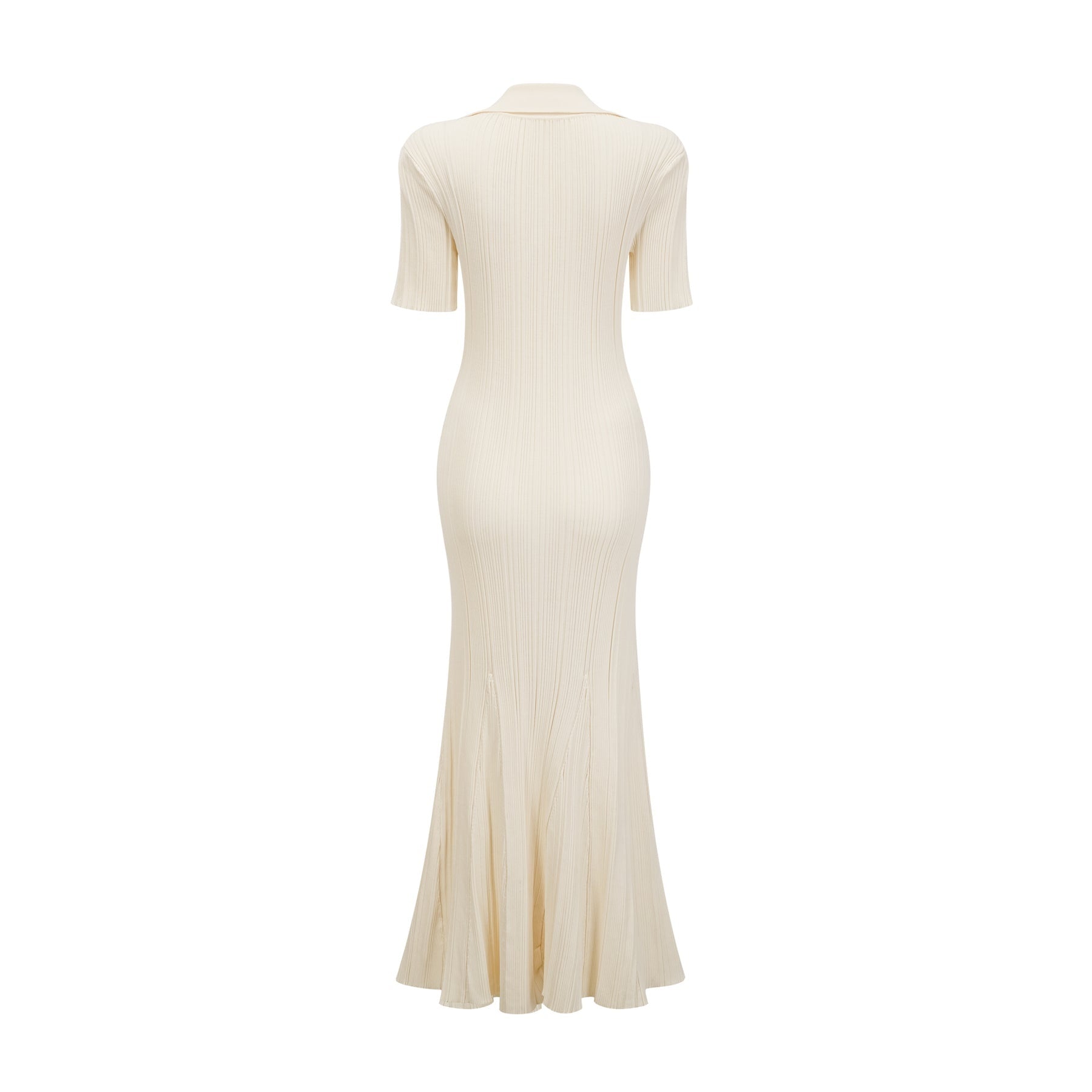 Woman wearing a beige ribbedknit midi dress with long sleeves and a formfitting silhouette standing against a plain background