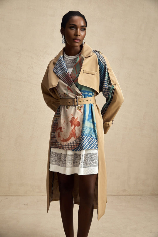Woman wearing a belted trench coat with contrasting color panels and printed design