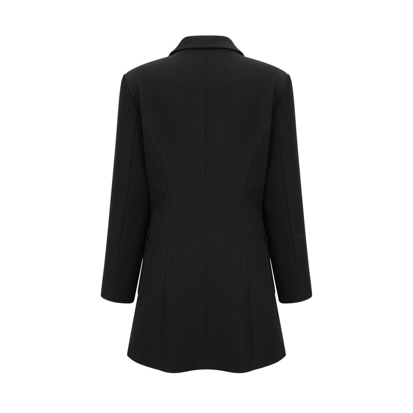 Woman wearing a black blazer dress with single breasted design and fitted silhouette