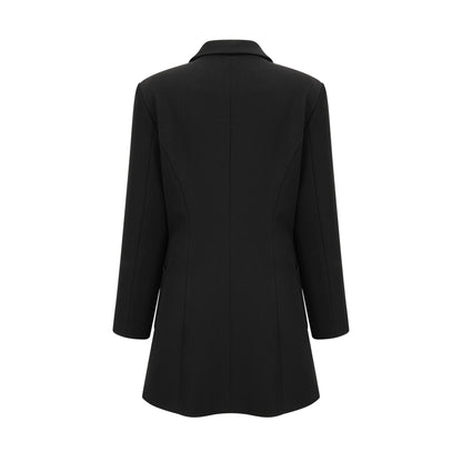 Woman wearing a black blazer dress with single breasted design and fitted silhouette