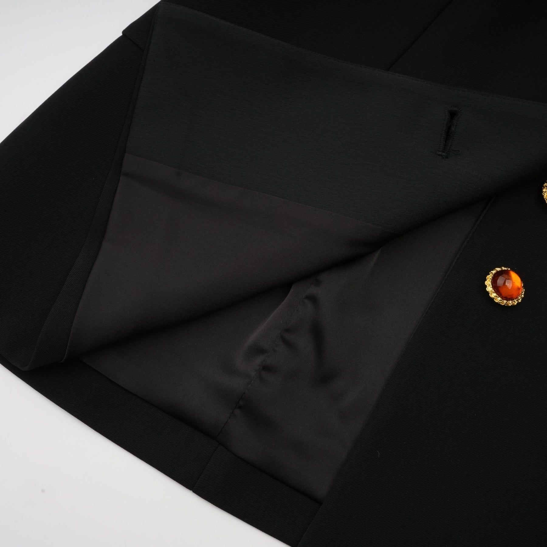 Woman wearing a black blazer dress with single button closure and slim fit silhouette