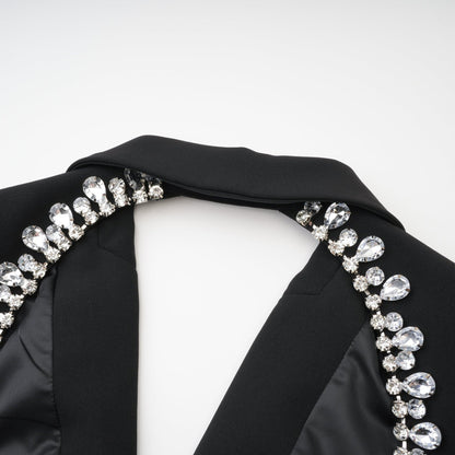 Elegant black dress with long sleeves notched lapels scoop back buttoned cuffs fitted waistline and crystal embellishment % Polyester