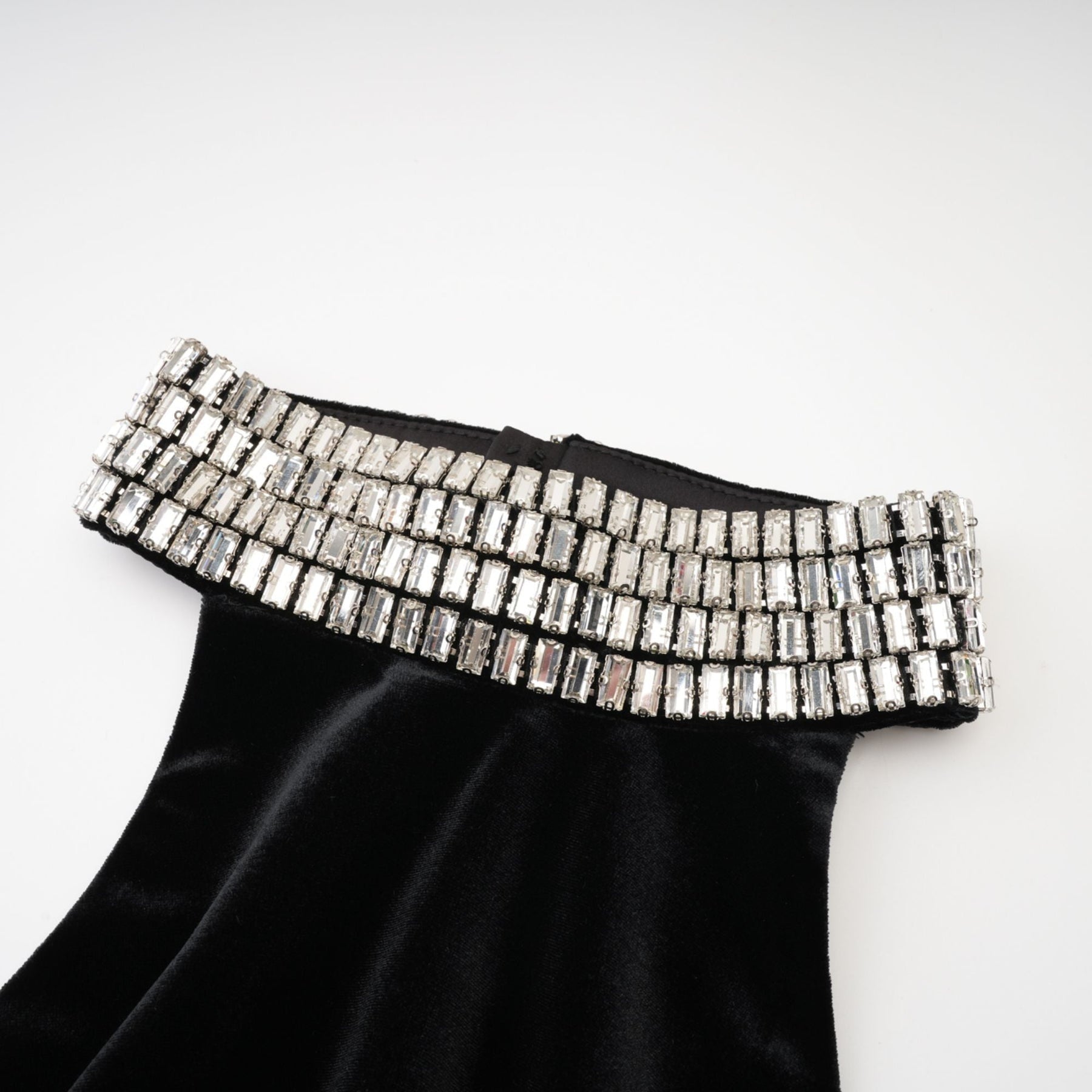 Sleeveless black dress with embellished crystal turtle neck ankle length rear zip fastening and side slit Made of 100% Polyester