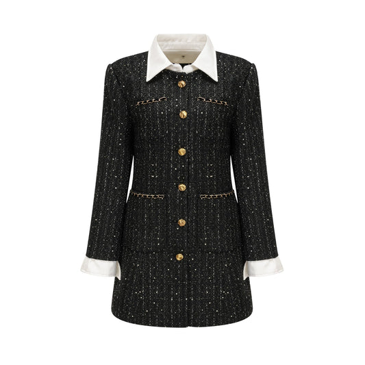 Woman wearing a black mini dress with sequin panels and tweed fabric featuring a sleeveless design and round neckline