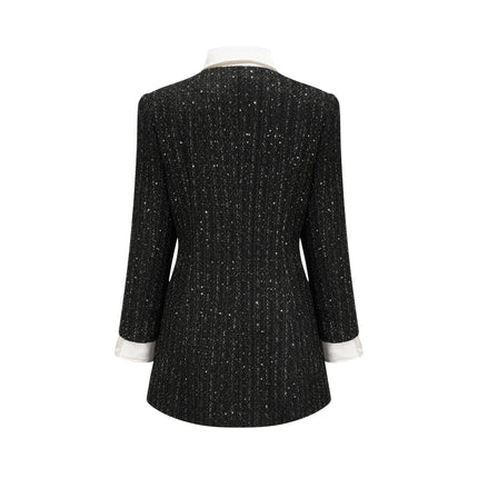 Woman wearing a black mini dress with tweed fabric and sequin panels Audrey style dress with short length and mixed textures