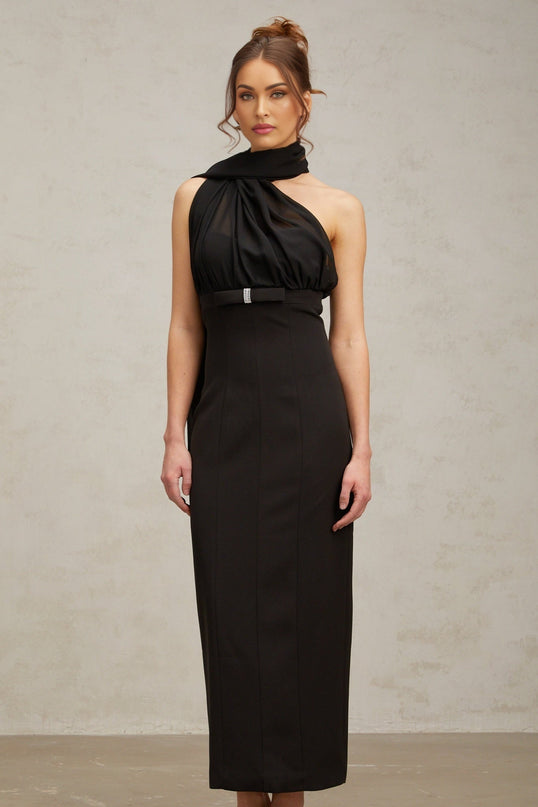 Woman wearing a black oneshoulder midi dress with draped design