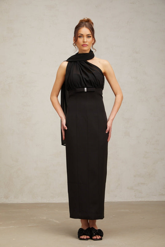 Woman wearing a black oneshoulder midi dress with draped detail