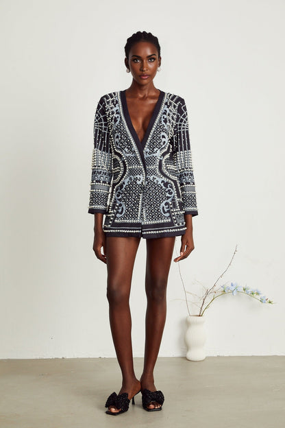 Woman wearing a blazer dress with Catherine pattern print and Vneck design