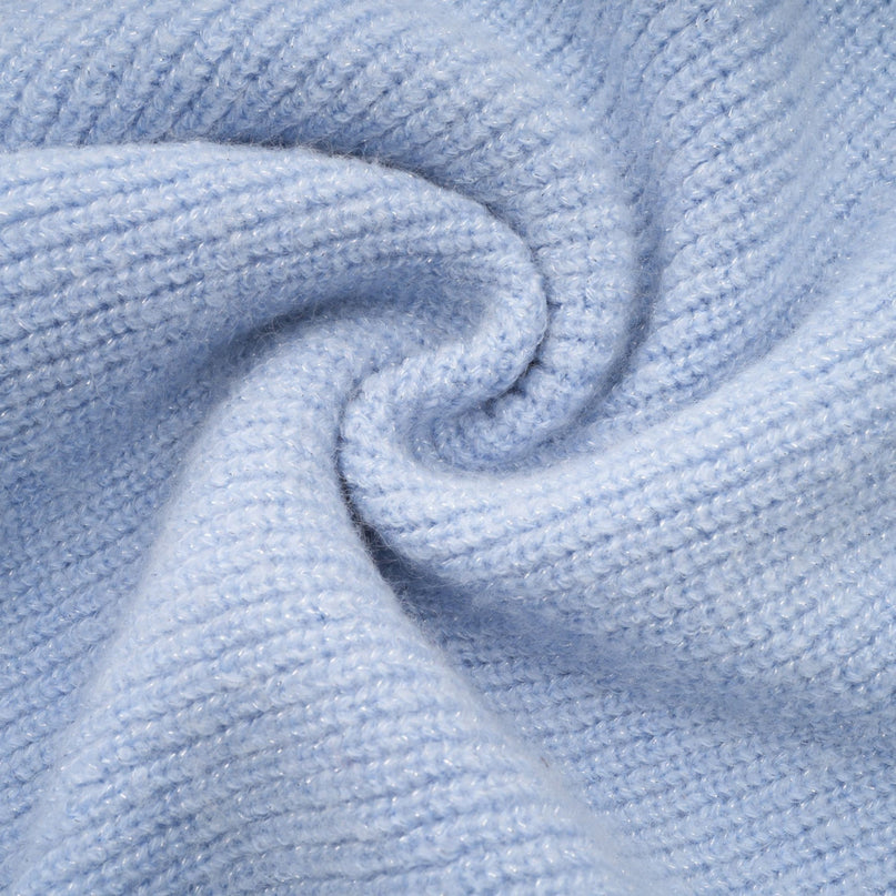 Woman wearing a blue knit blouse and matching skirt set called Chantal The outfit features a coordinated top and bottom in a soft knitted fabric with a blue color