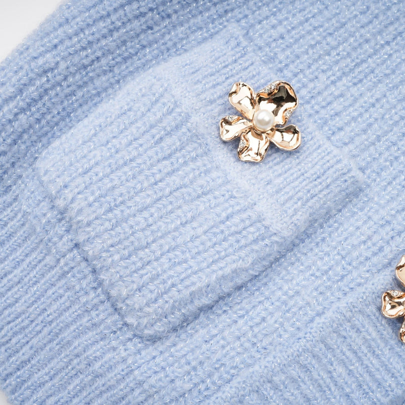 Woman wearing a blue knit blouse and matching skirt set named Chantal standing against a plain background