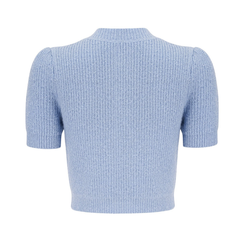 Woman wearing a blue knit matching set consisting of a blouse and skirt Chantal style outfit in a soft knit fabric