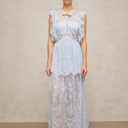 Woman wearing a blue lace maxi dress with layered skirt and capucine style neckline