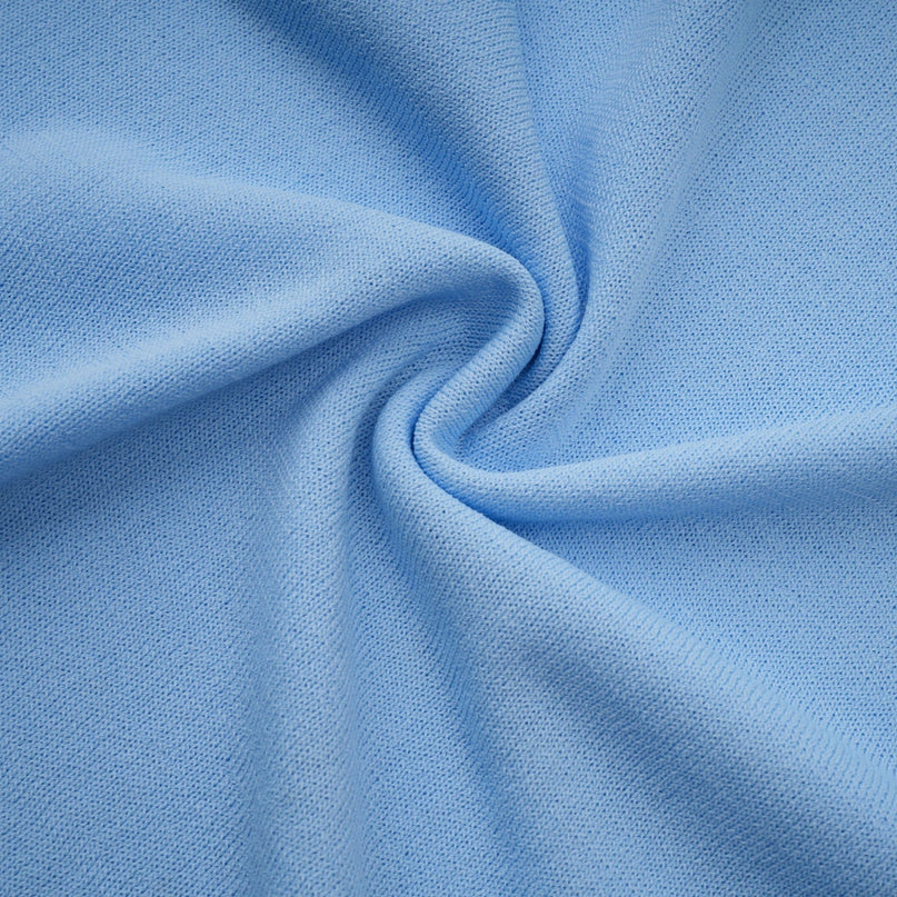 Woman wearing a blue midi dress with crochet knit pattern and ruffled trim details