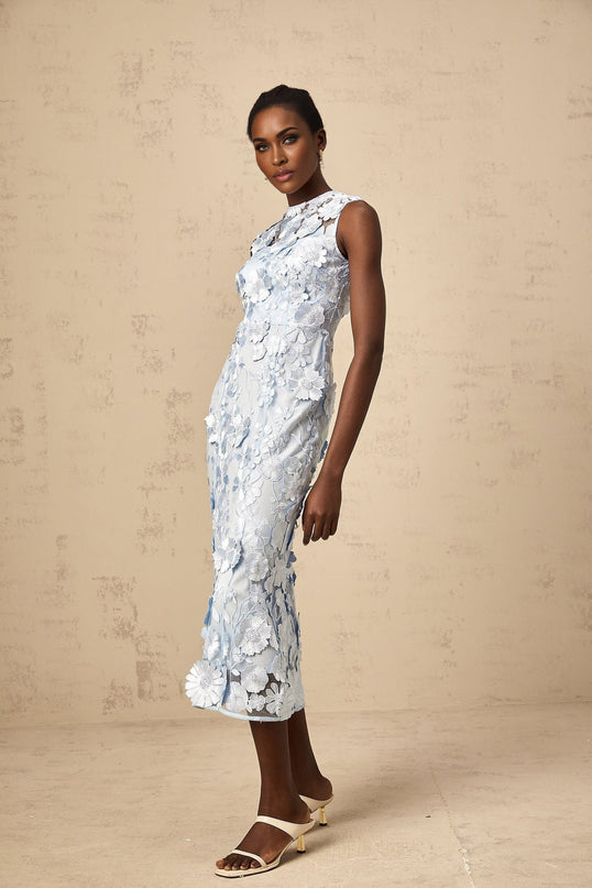 Woman wearing a blue midi dress with floral applique details