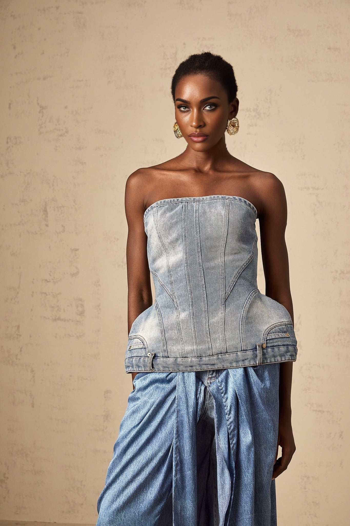 Woman wearing a blue offshoulder denim top with long sleeves