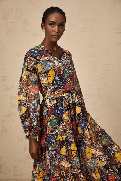 Woman wearing a brown bohemian style midi dress with shirring detail and flowing fabric