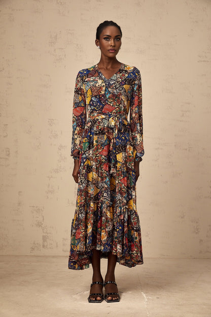 Woman wearing a brown bohemian style midi dress with shirring detail and flowing skirt