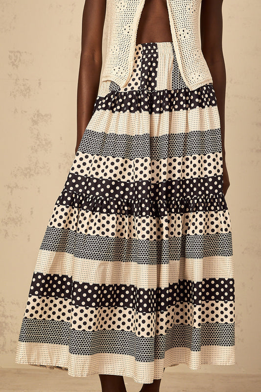 Woman wearing a colorblock skirt with polka dot pattern and shirred waistline