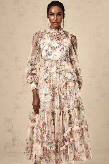 Woman wearing a floral patterned midi dress with ruffled tulle details and a fitted waist