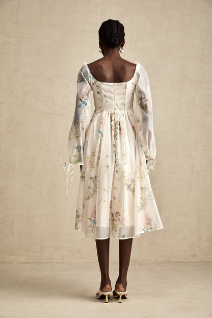 Woman wearing a floral print midi dress with square neckline and Anne design
