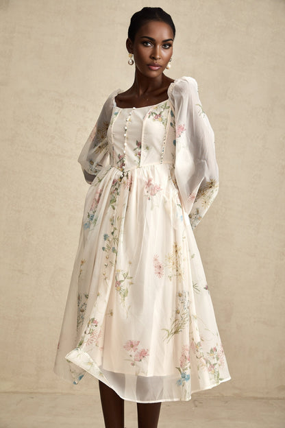 Woman wearing a floral print midi dress with square neckline named Anne