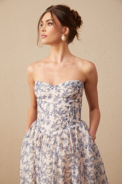 Woman wearing a floral print offshoulder midi dress with a fitted bodice and flared skirt