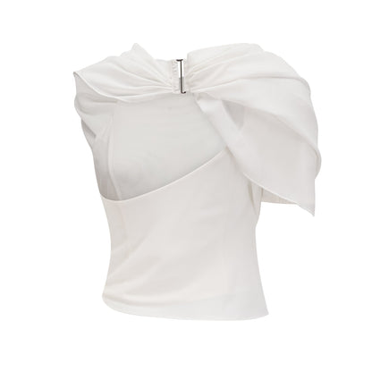 Woman wearing a flowing white chiffon blouse named Jeanne with loose sleeves and delicate fabric