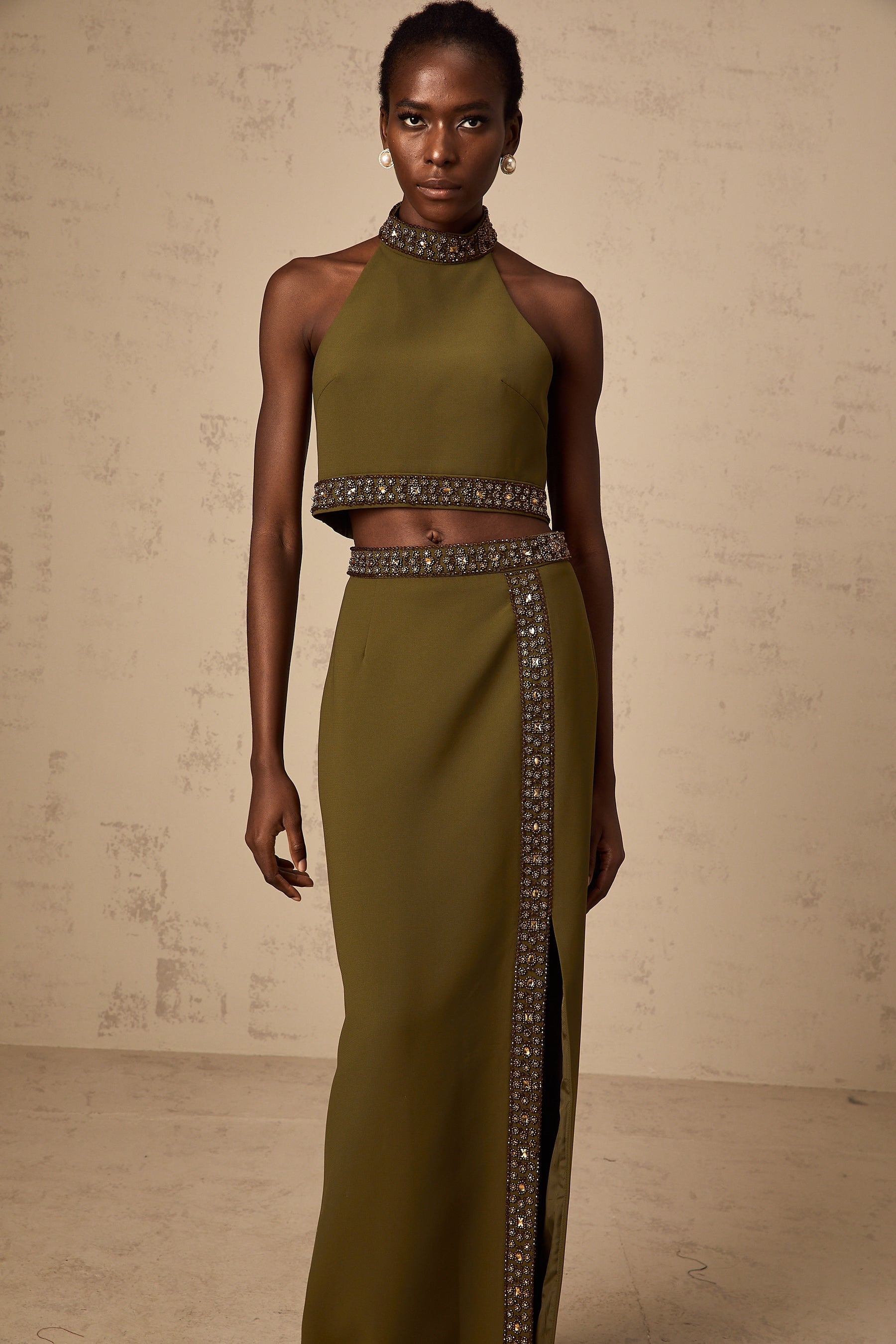 Woman wearing a green daisy patterned top and matching skirt with beaded trim detail