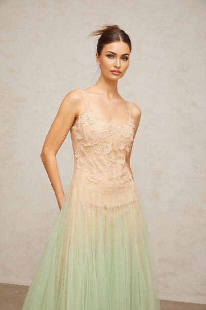 Woman wearing a green midi dress with lace panels and tulle skirt