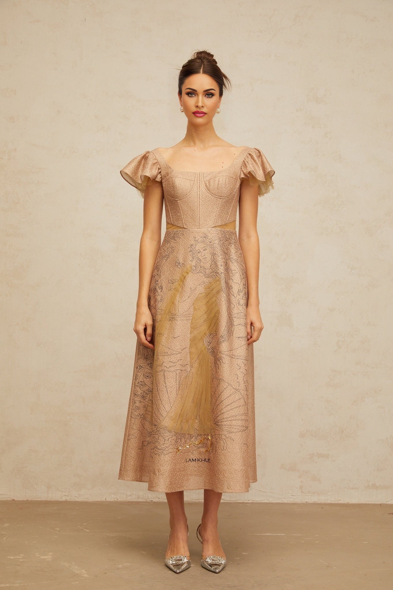 Woman wearing a khaki midi dress with flared skirt and graphic print pattern standing in neutral pose