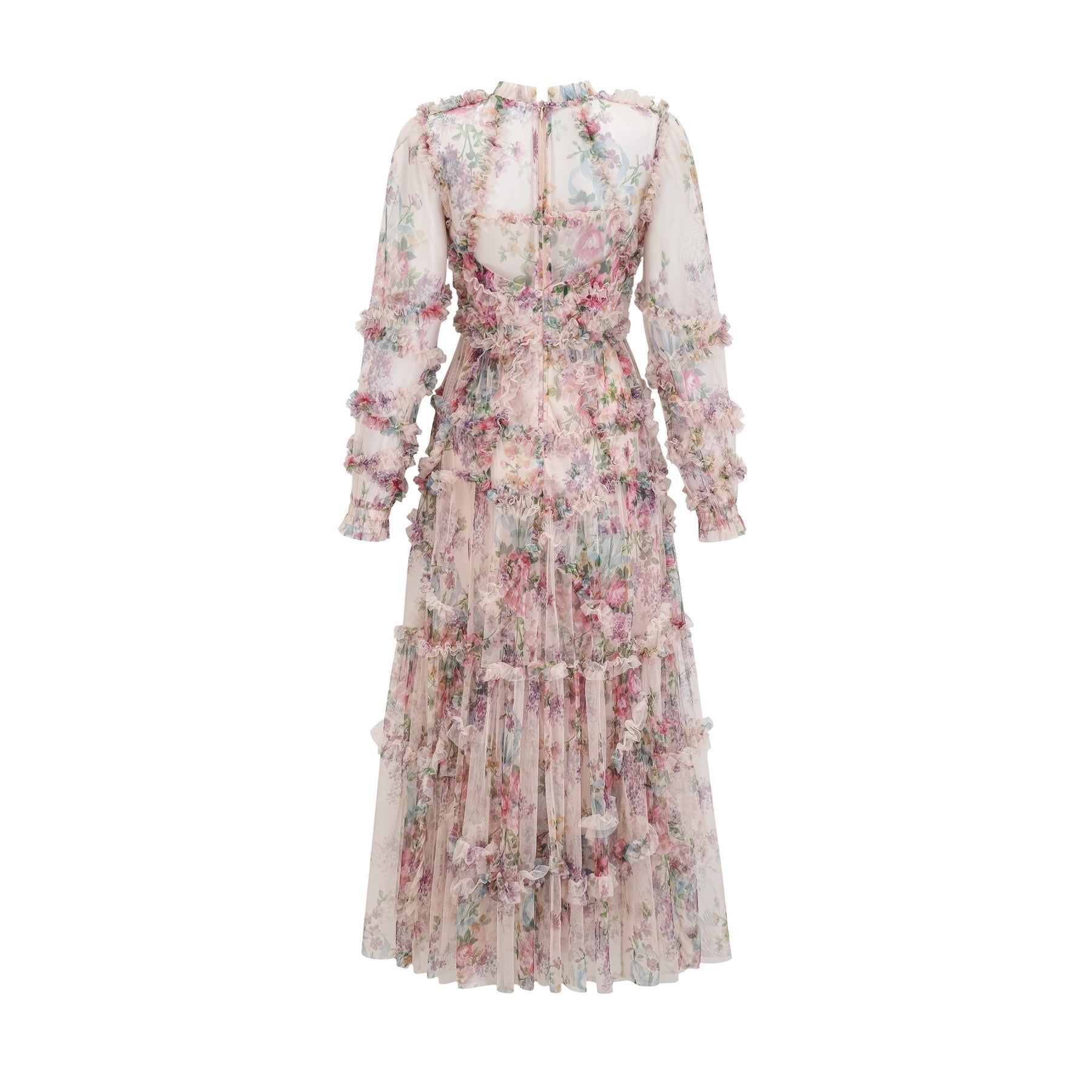 Woman wearing a lightcolored floral midi dress with ruffled details and tulle fabric standing in a neutral background