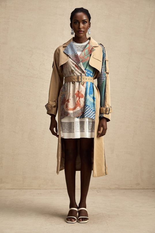Woman wearing a long belted trench coat with contrasting colors and printed design