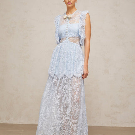 Woman wearing a long blue lace maxi dress with layered skirt and capucine neckline