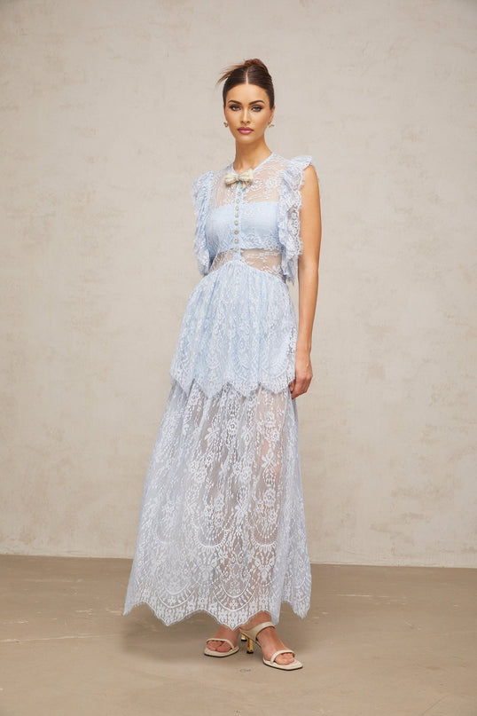 Woman wearing a long blue lace maxi dress with layered skirt and capucine neckline